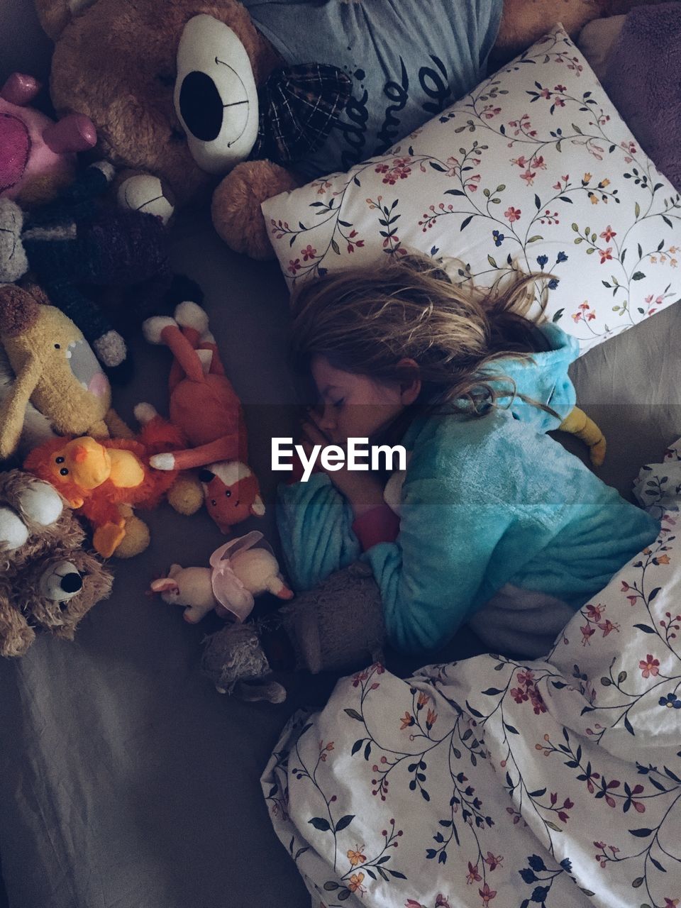 High angle view of girl sleeping on bed at home