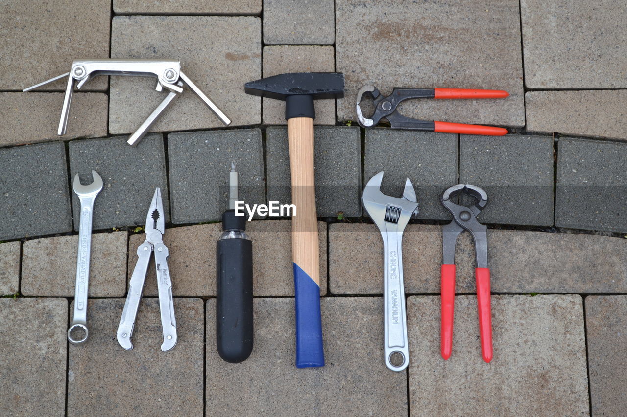 High angle view of work tools on paved street