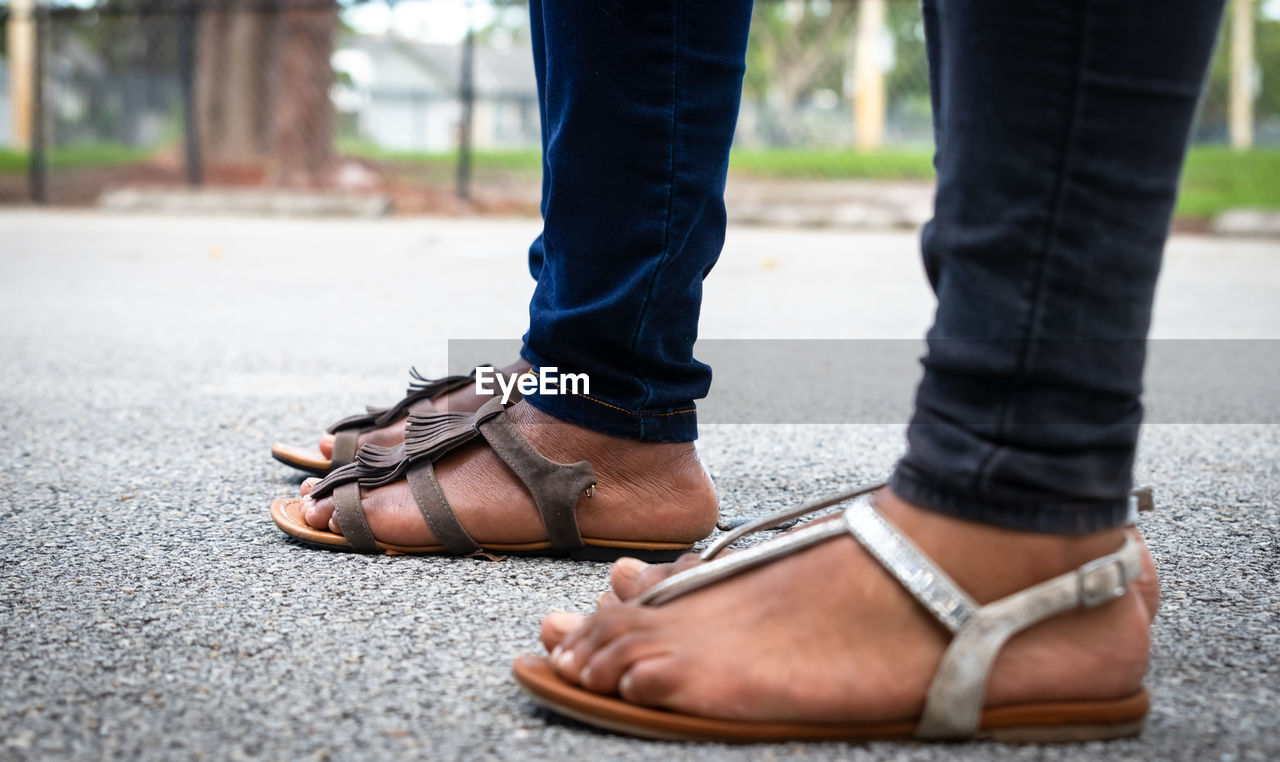LOW SECTION OF MAN WEARING LEATHER SHOES