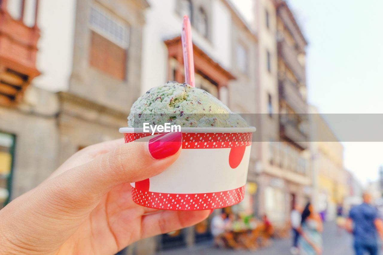 Close-up of hand holding ice cream cone