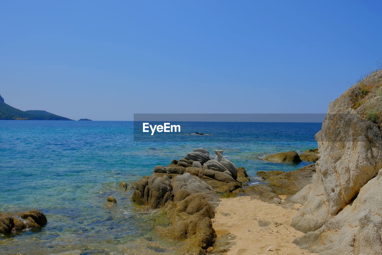 Scenic view of sea against clear blue sky