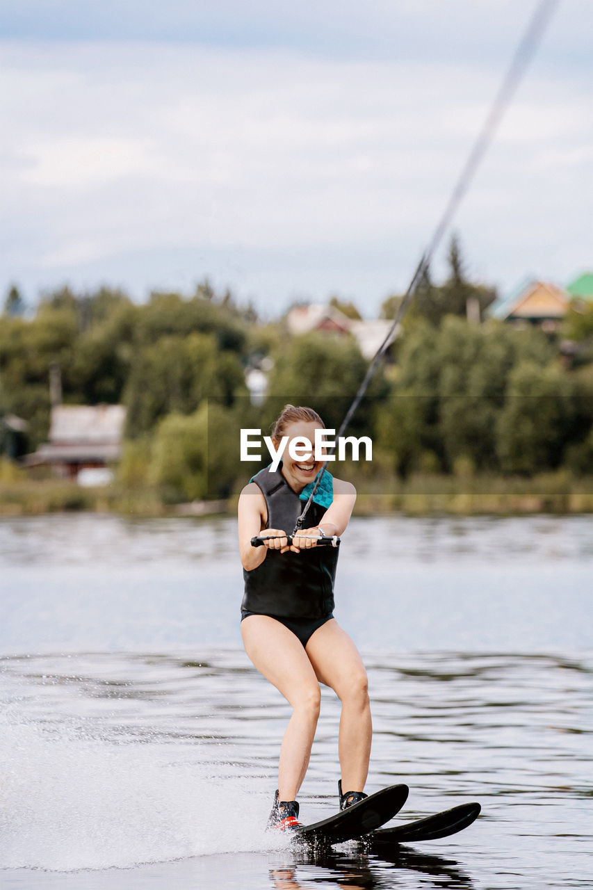 Full length portrait of woman in lake