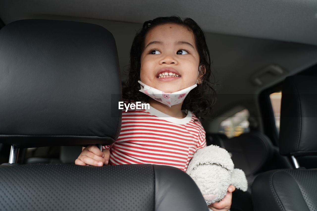 Portrait of girl sitting in car