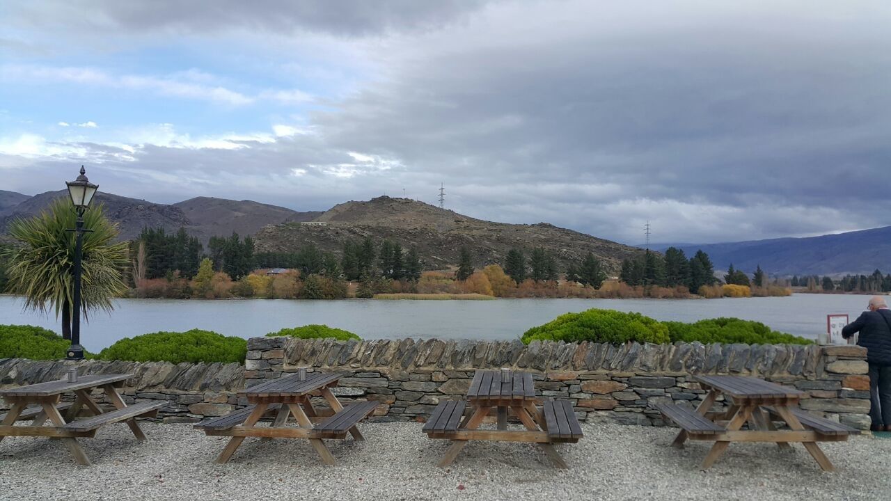 sky, mountain, cloud, water, nature, scenics - nature, lake, land, seat, travel destinations, tree, adult, beauty in nature, mountain range, beach, men, travel, environment, architecture, full length, furniture, plant, landscape, chair, vacation, trip, holiday, outdoors, tranquility, tourism, day, leisure activity, lifestyles, tranquil scene, relaxation, table, shore