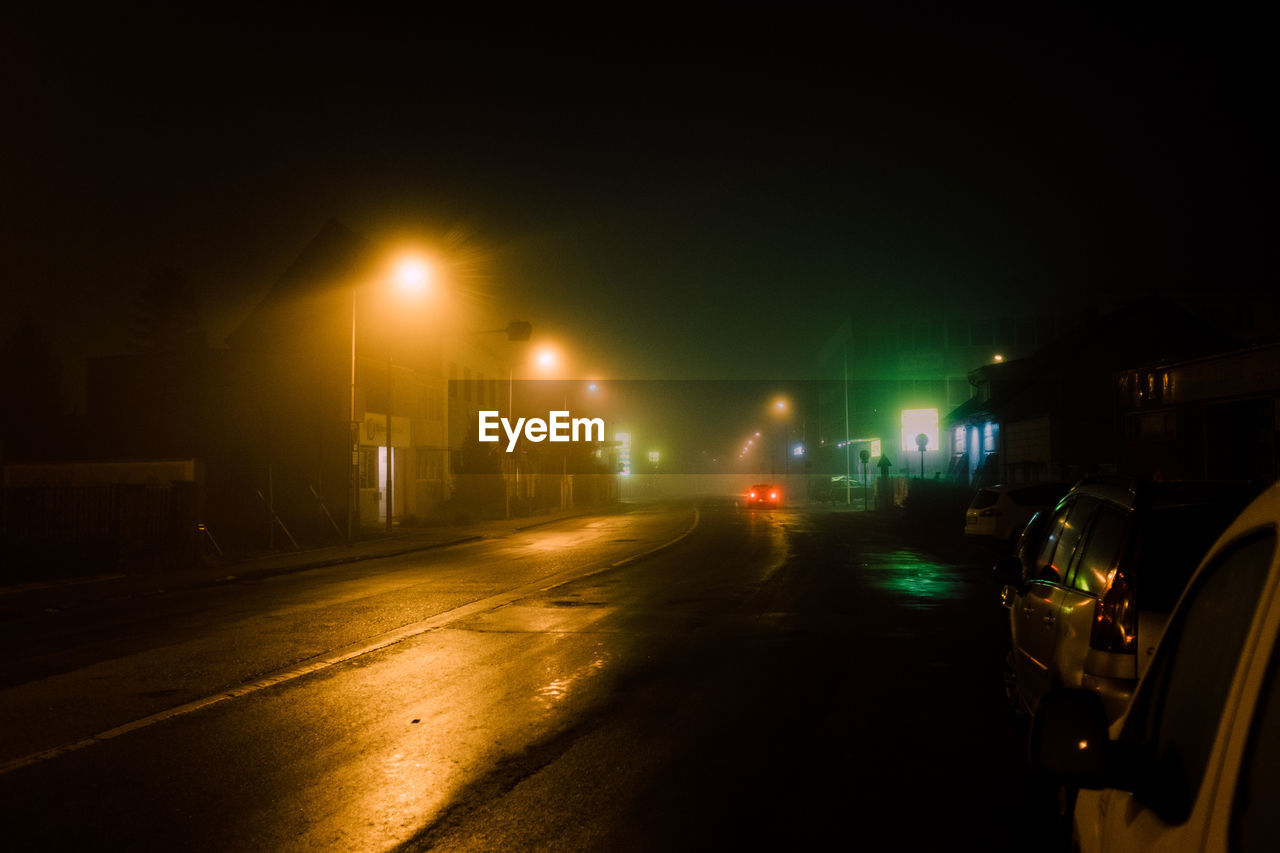 Cars on road in city at night