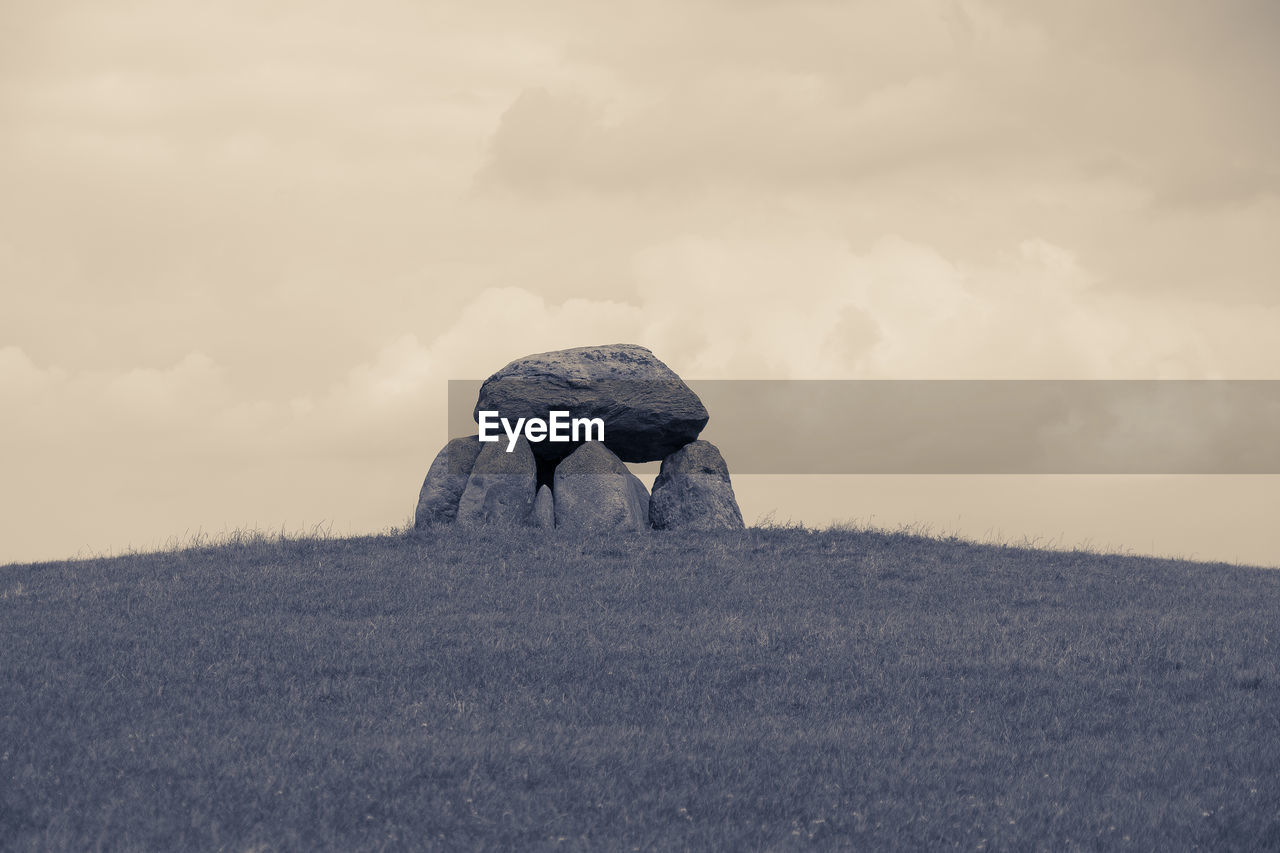 VIEW OF ROCK ON FIELD