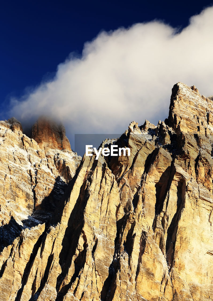 Low angle view of rock formation against sky