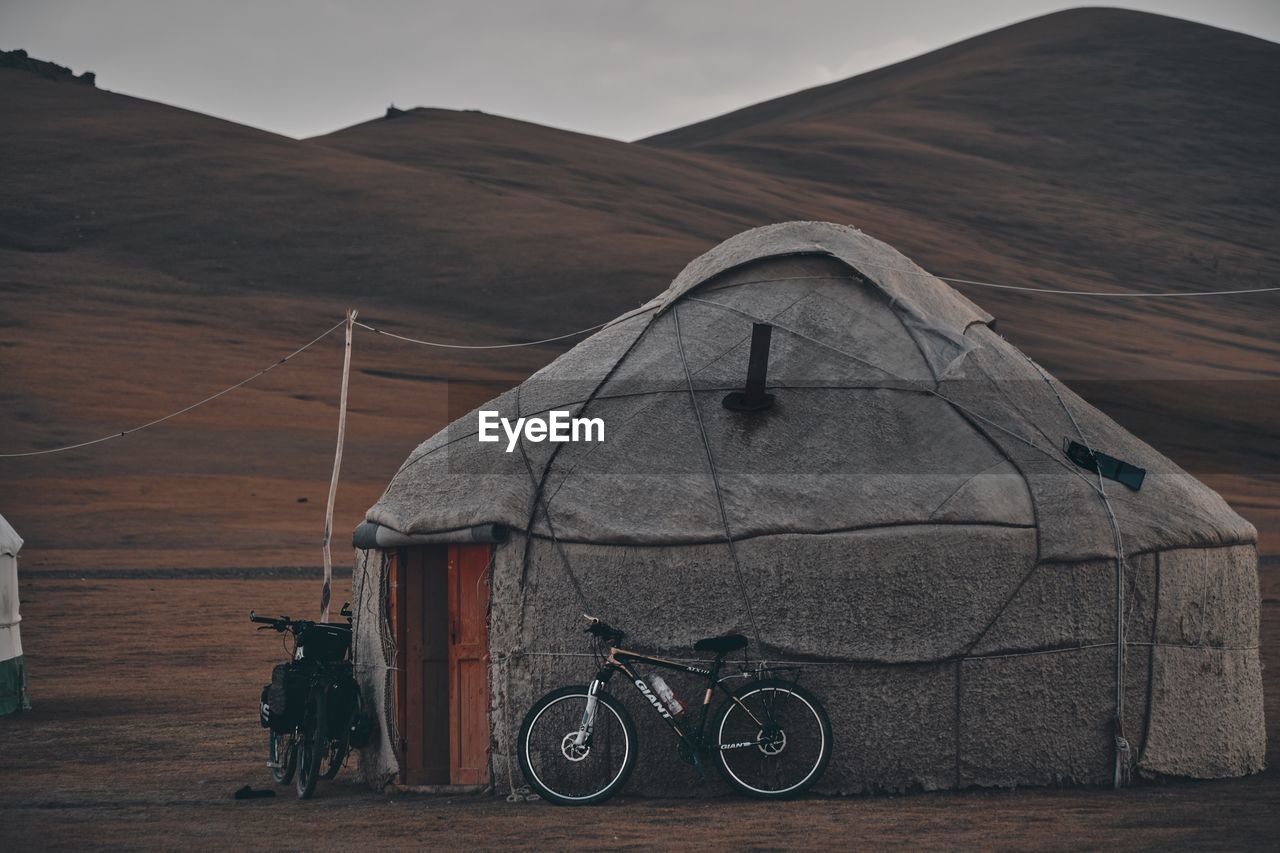 REAR VIEW OF TENT AGAINST MOUNTAIN