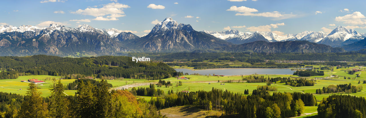 Scenic view of field and mountains against sky