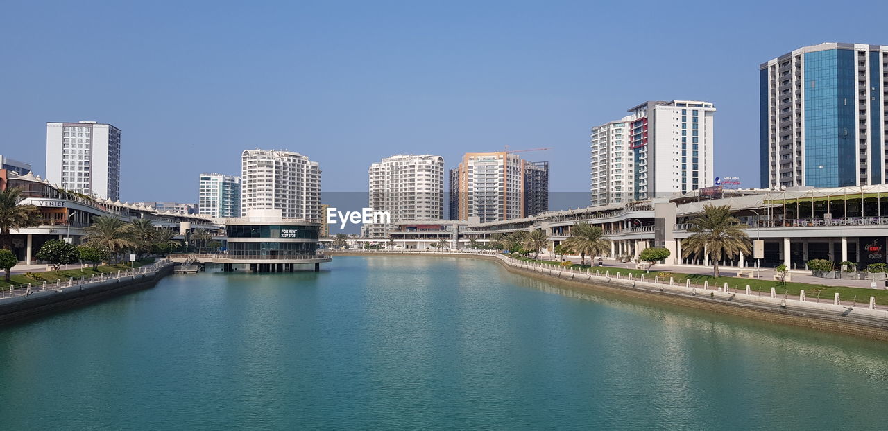 VIEW OF MODERN BUILDINGS AGAINST BLUE SKY