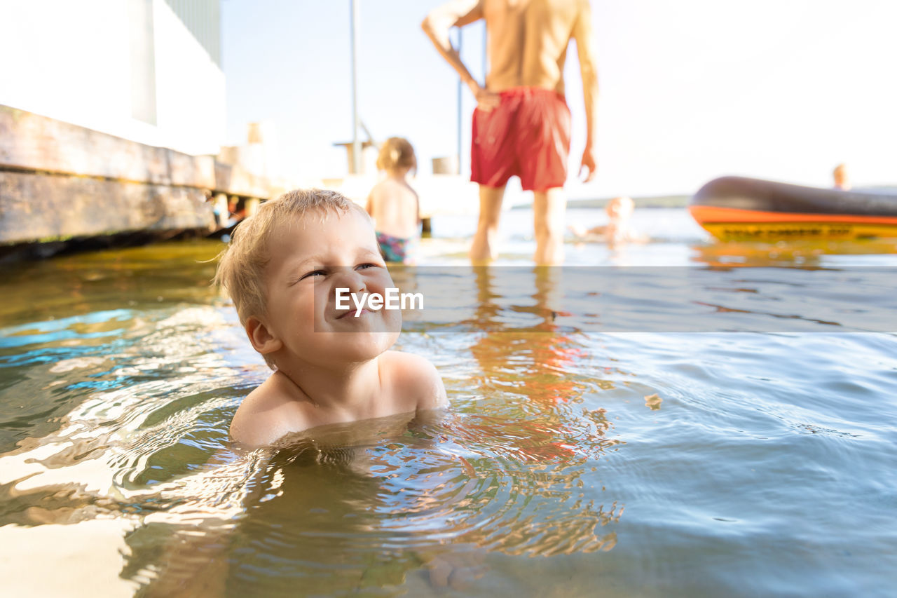 Close-up of boy playing in water outdoors