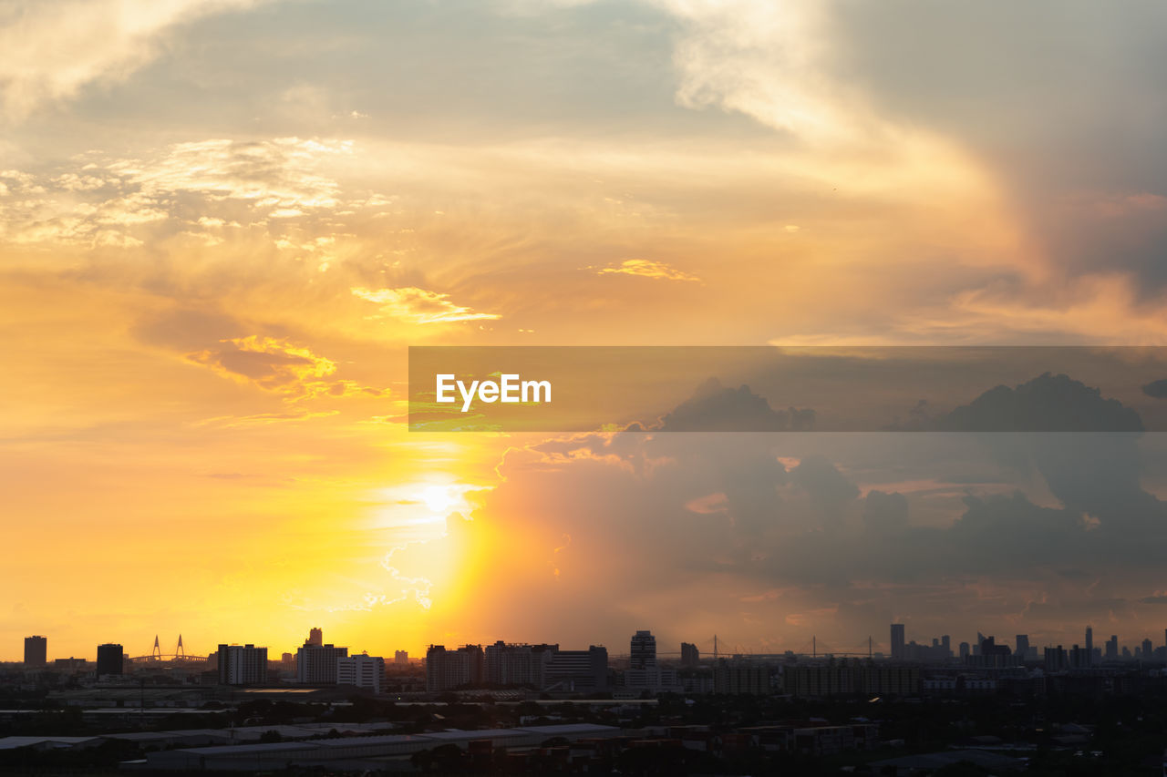 Scenic view of buildings against sky during sunset