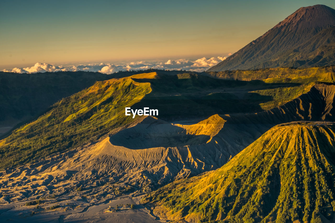 Aerial view of snowcapped mountain against sky during sunset