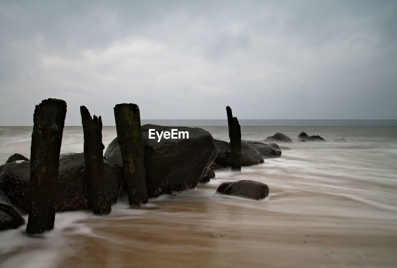 Rocks and wooden posts at beach