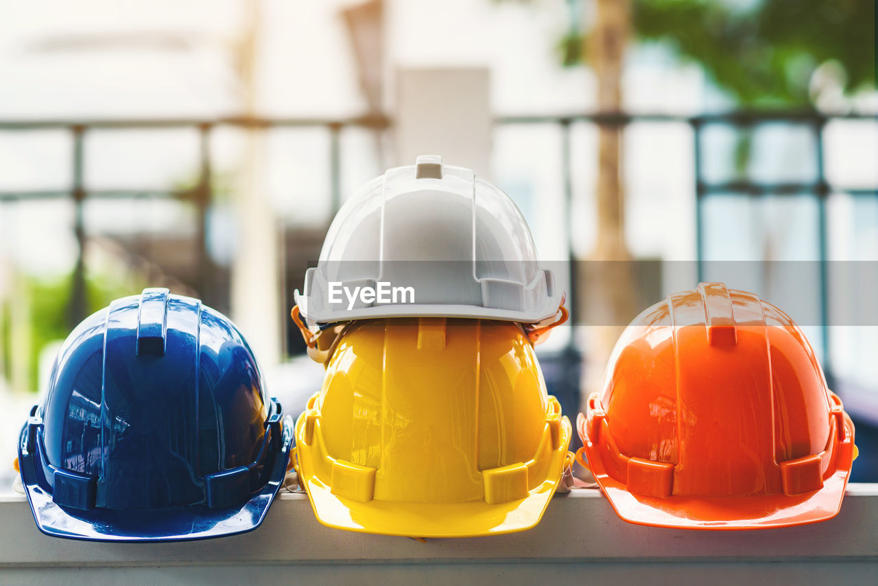 White, yellow and other colored safety helmets for workers' safety projects in the position 