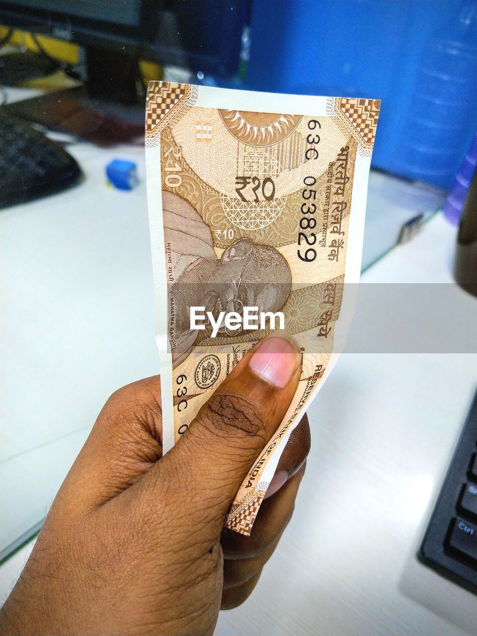 Close-up of person holding paper currency