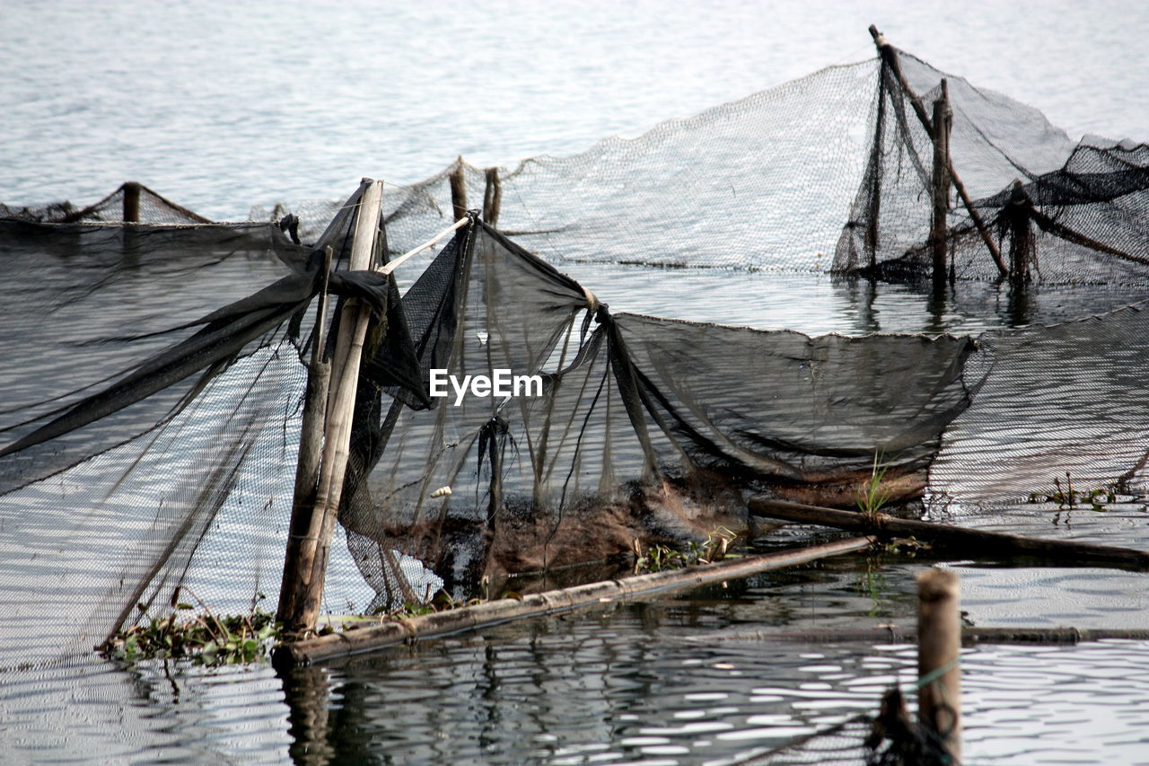 High angle view of fishing nets tied in sea