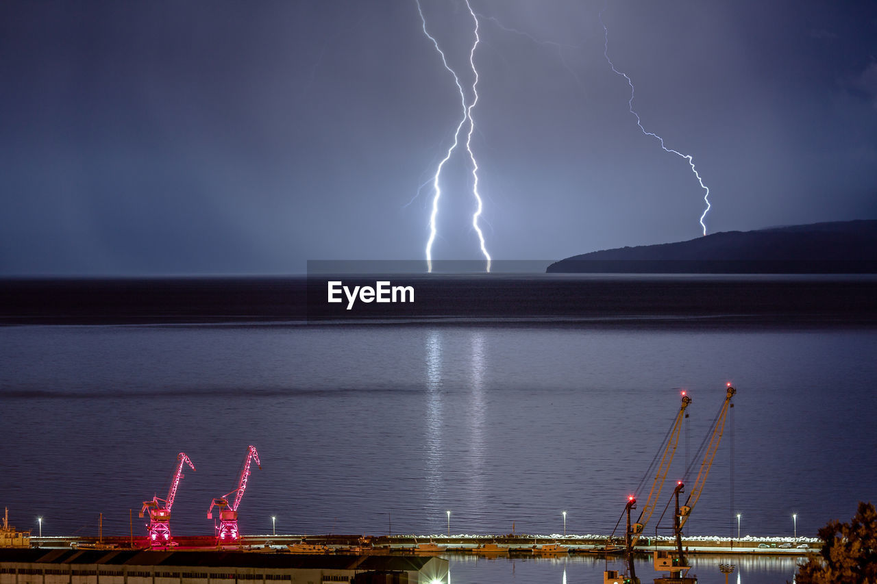 FIREWORK DISPLAY OVER LAKE AGAINST SKY