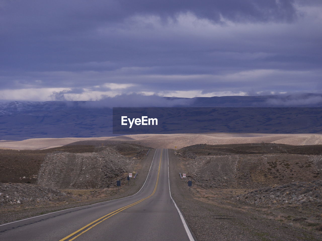 Empty road along countryside landscape