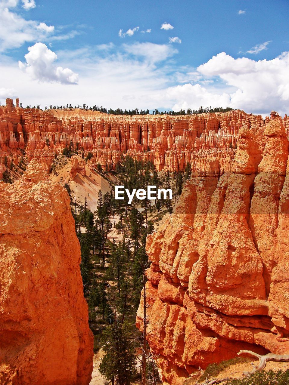 Rock formations against cloudy sky