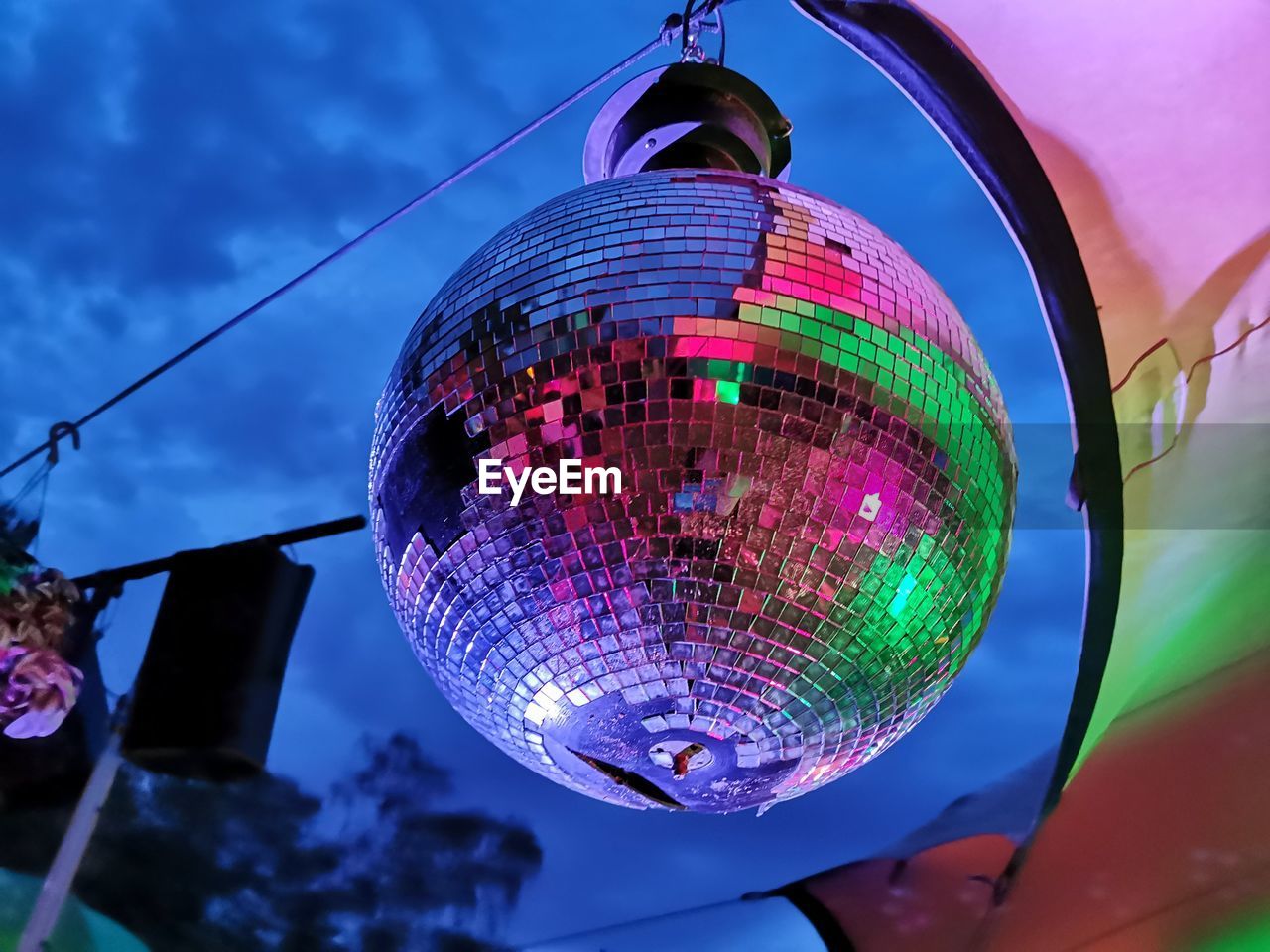 LOW ANGLE VIEW OF ILLUMINATED LANTERNS HANGING FROM CEILING