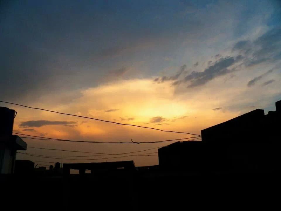 LOW ANGLE VIEW OF BUILDINGS AGAINST SKY AT SUNSET