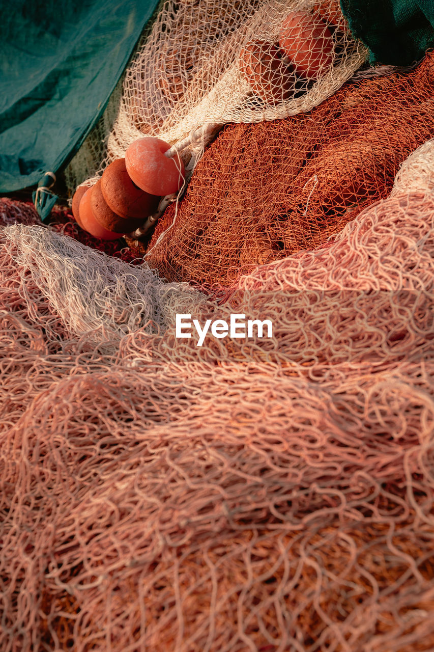fishing net, commercial fishing net, fishing industry, fishing, land, day, high angle view, one person, nature, food and drink