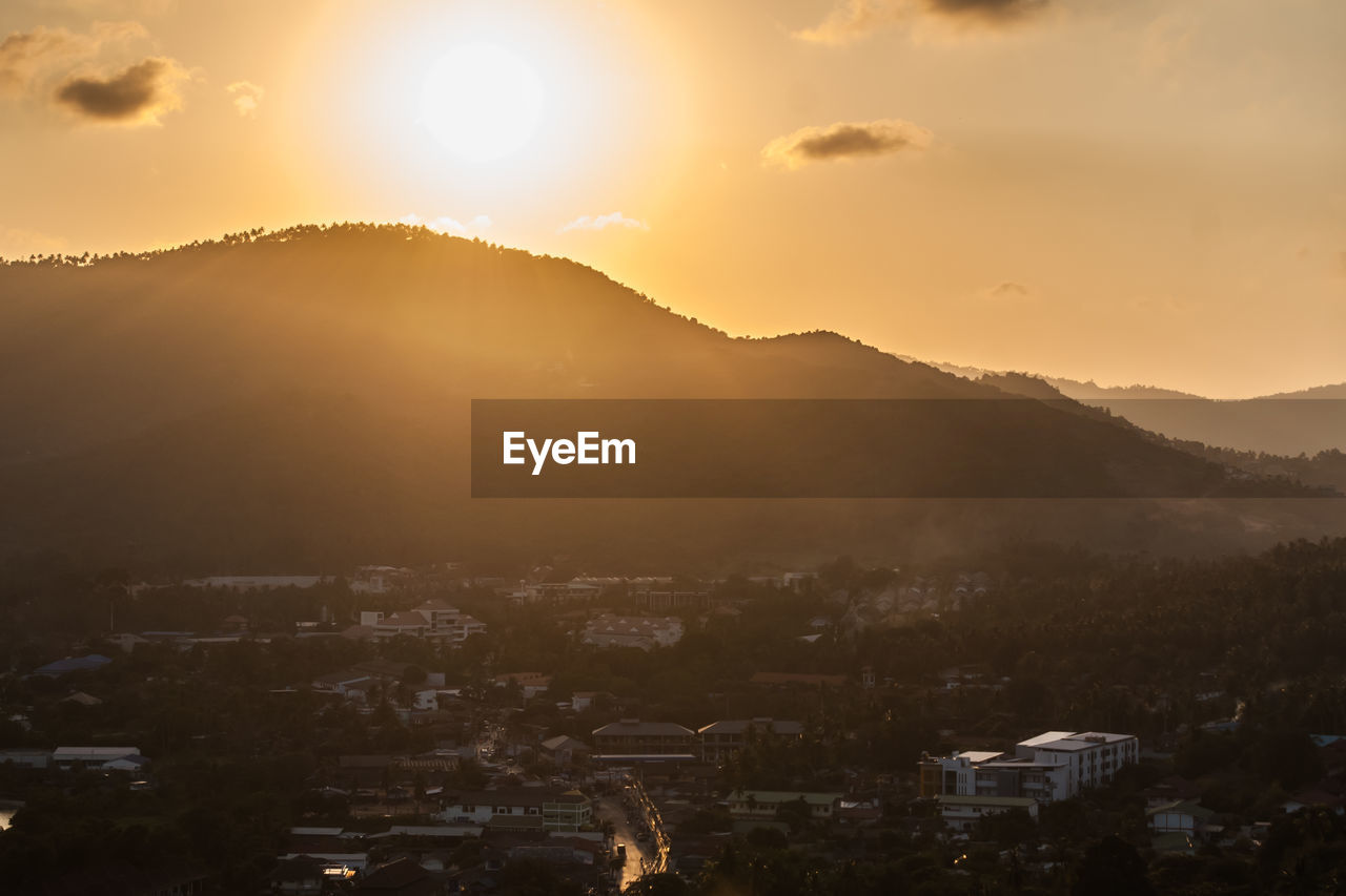 Scenic view of mountains against sky at sunset