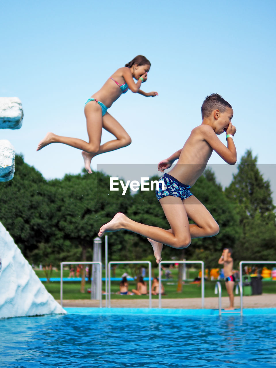 Boy jumping in swimming pool