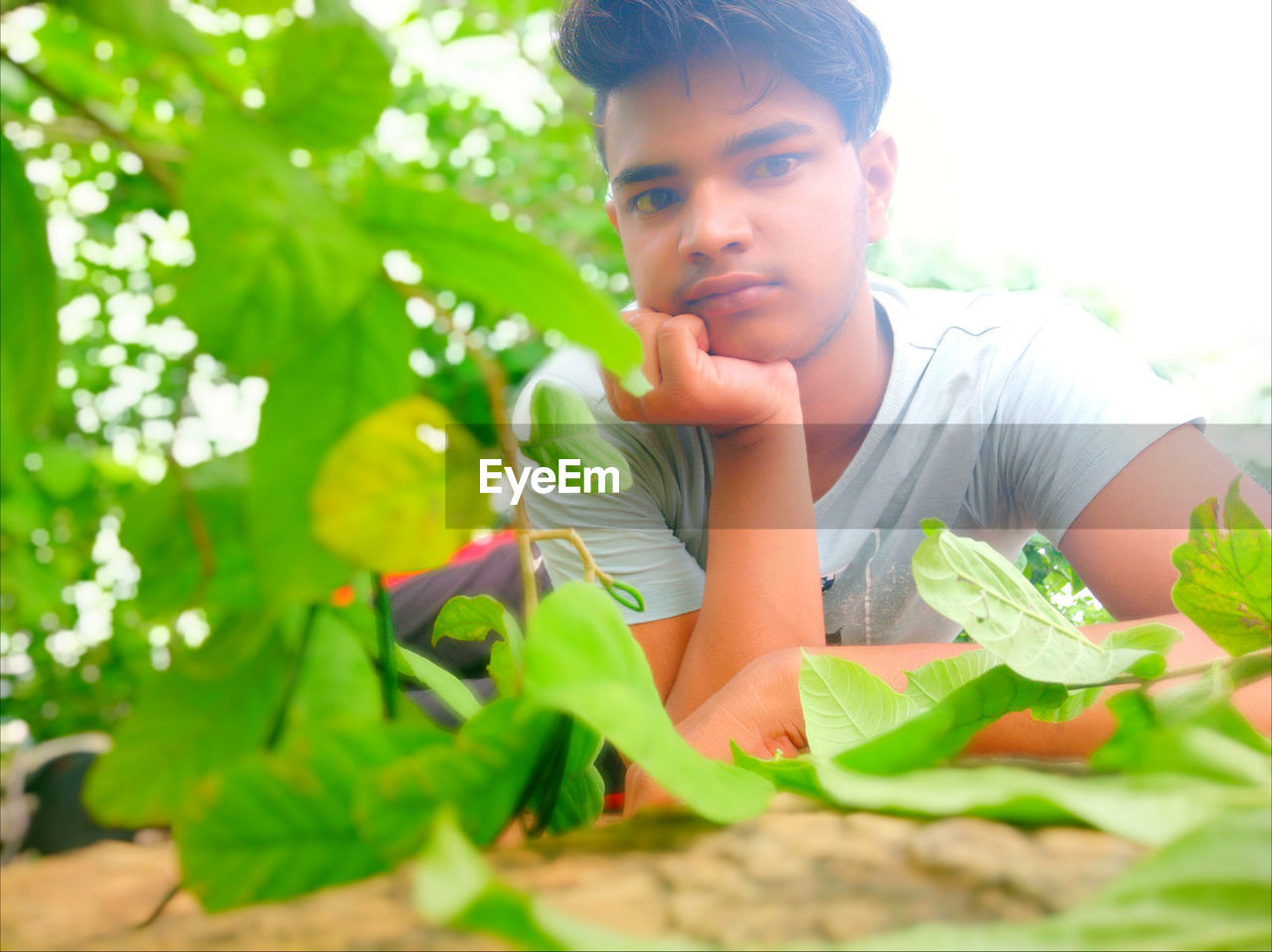 Portrait of young man by plants