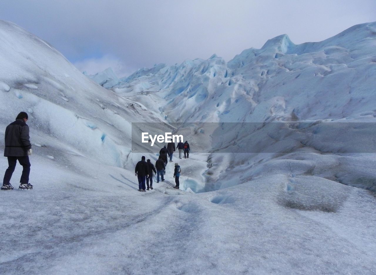 Rear view of people hiking at moreno glacier