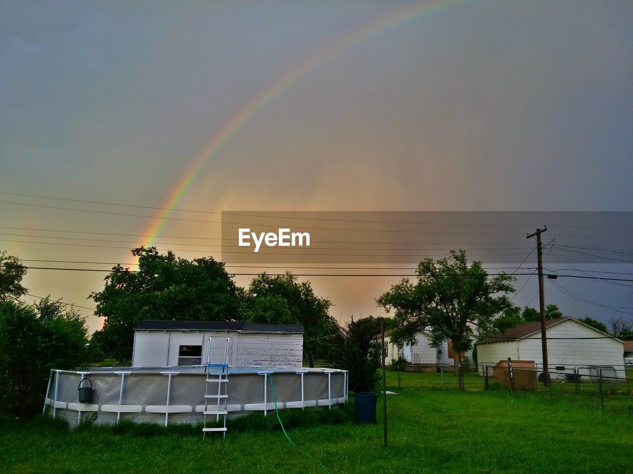 RAINBOW OVER TREES AND HOUSES