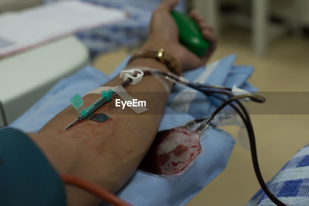 Cropped hand of patient with iv drip in hospital