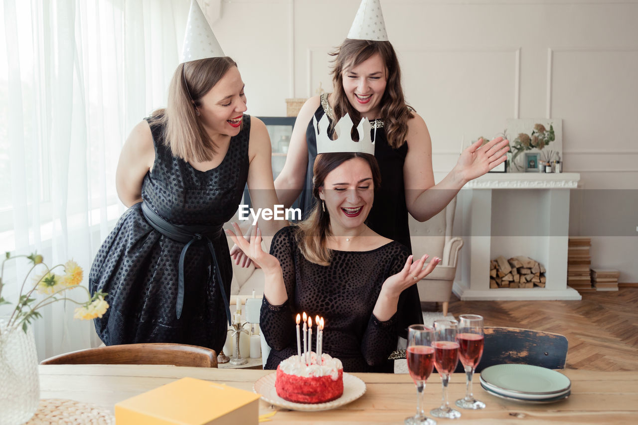 Happy women celebrating birthday at home