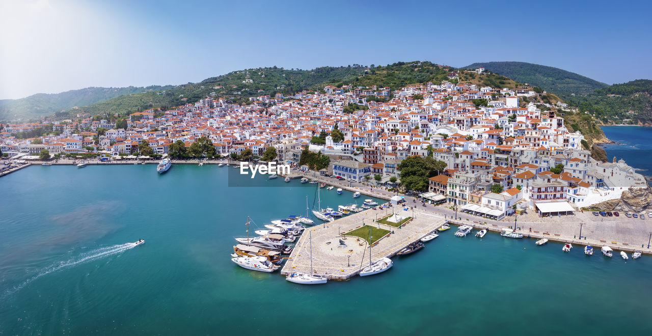 high angle view of city by sea against sky