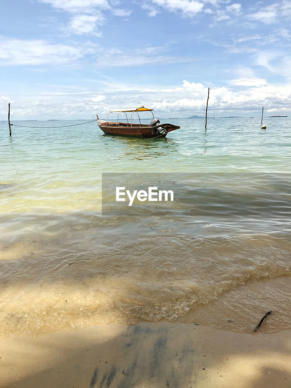 water, nautical vessel, shore, sea, beach, transportation, land, mode of transportation, sky, nature, coast, ship, sand, wave, boat, ocean, beauty in nature, cloud, travel, scenics - nature, vehicle, tranquility, body of water, day, outdoors, no people, watercraft, tranquil scene, bay, travel destinations, horizon over water, moored, sunlight, holiday, horizon, vacation