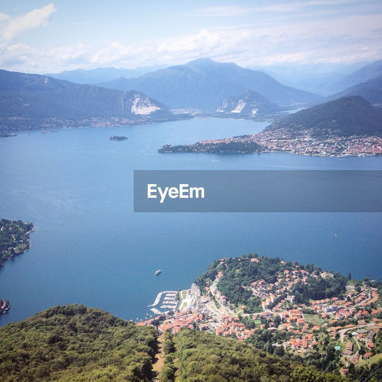 Scenic view of sea and mountains against sky