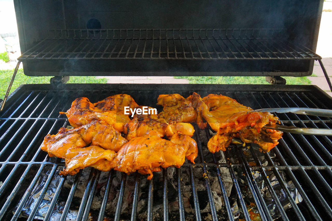 Marinated chicken cooking on the grill