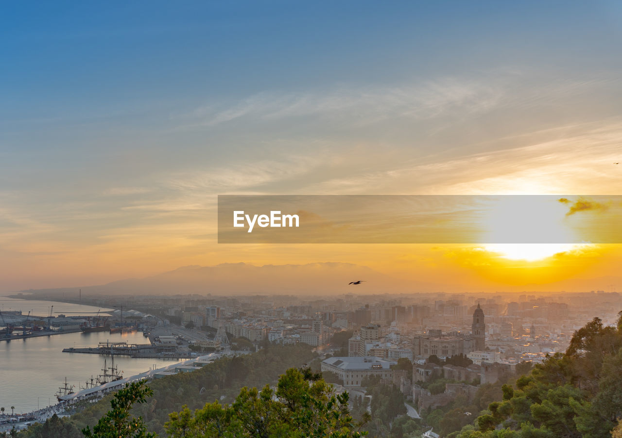 HIGH ANGLE VIEW OF BUILDINGS DURING SUNSET