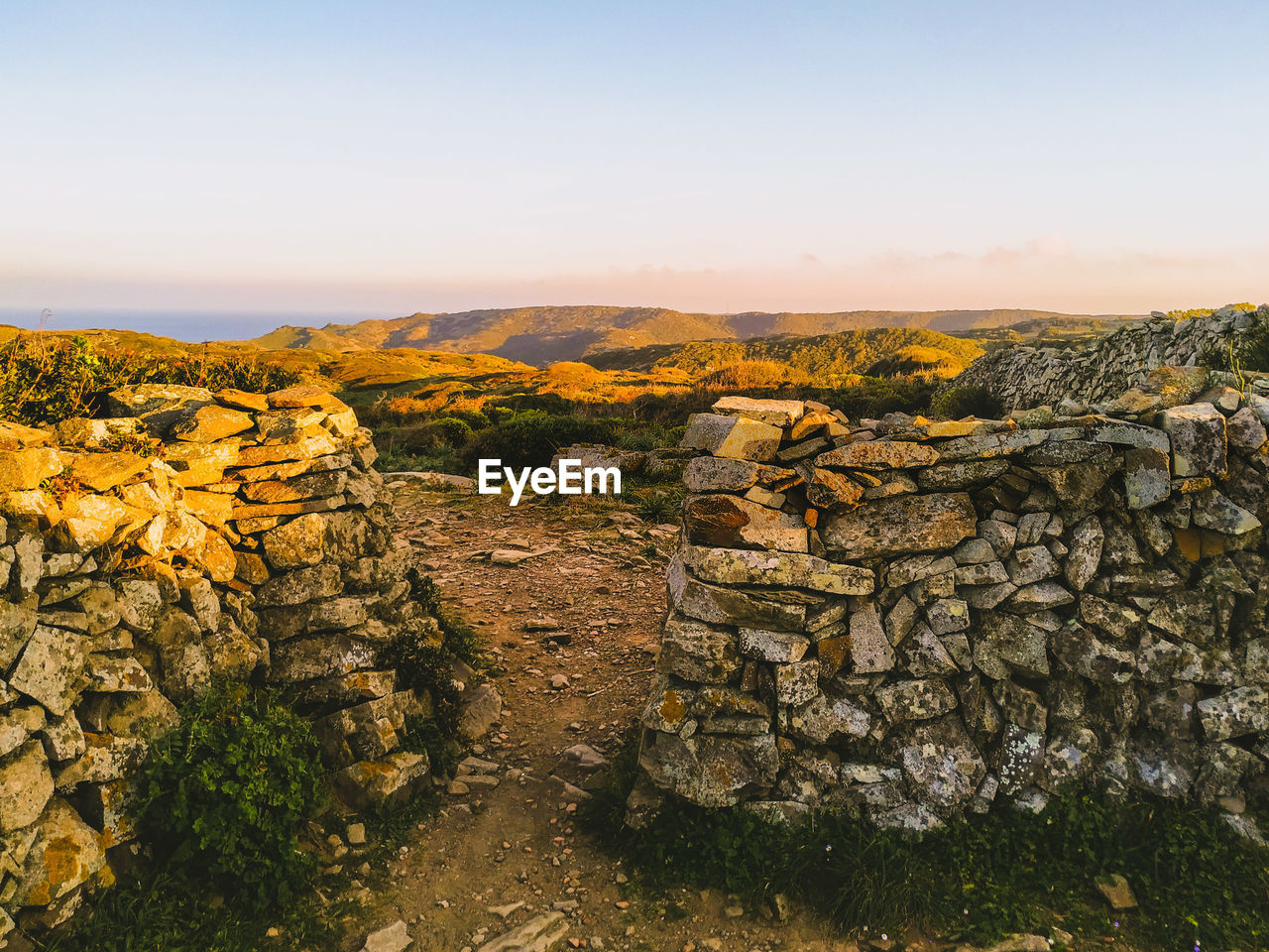 Scenic view of landscape against clear sky during sunset