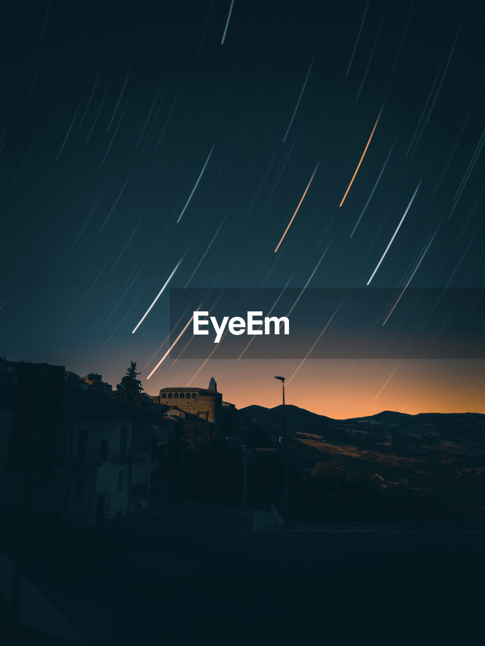 Silhouette buildings against sky at night