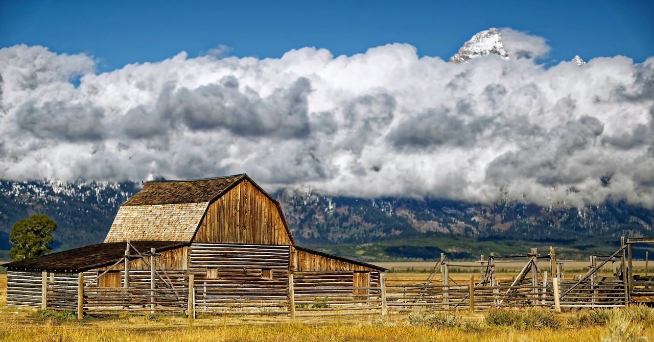 Barn on field against sky