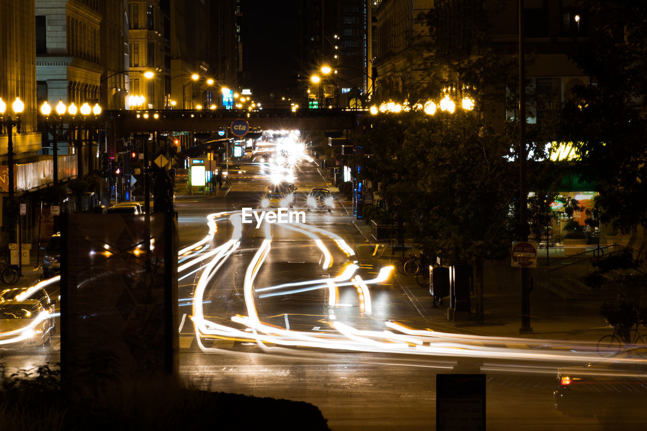 ILLUMINATED LIGHT TRAILS ON ROAD AT NIGHT