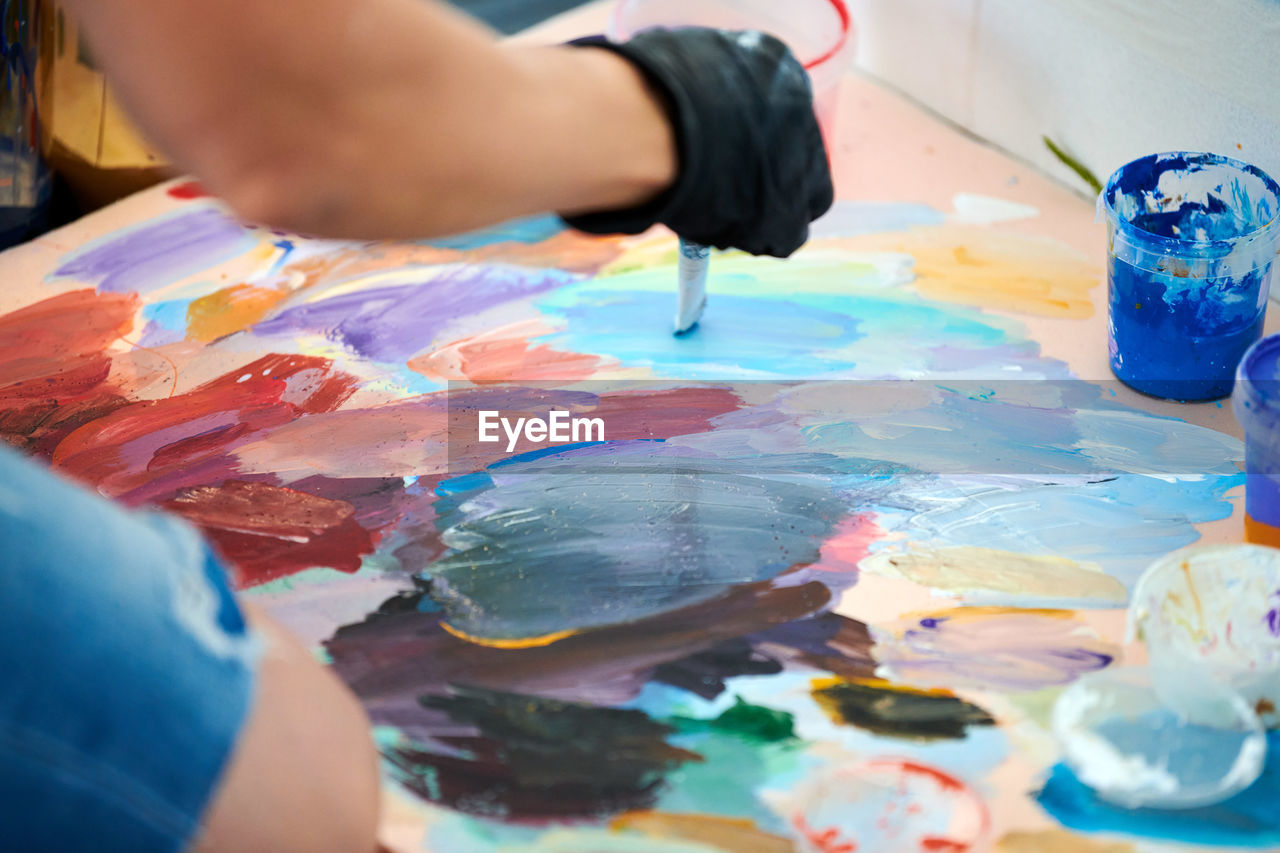paint, brush, painting, creativity, paintbrush, palette, indoors, occupation, painter, multi colored, craft, art, hand, studio, adult, art and craft equipment, artist's canvas, selective focus, art studio, skill, painted image, blue, one person, close-up, drawing, painted, oil paint, acrylic painting