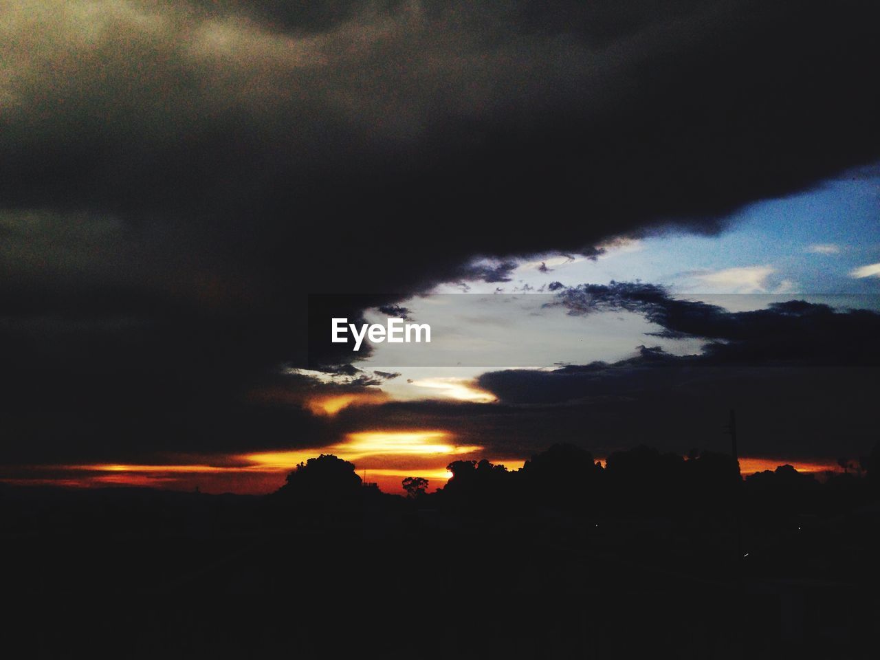 DRAMATIC SKY OVER SILHOUETTE LANDSCAPE