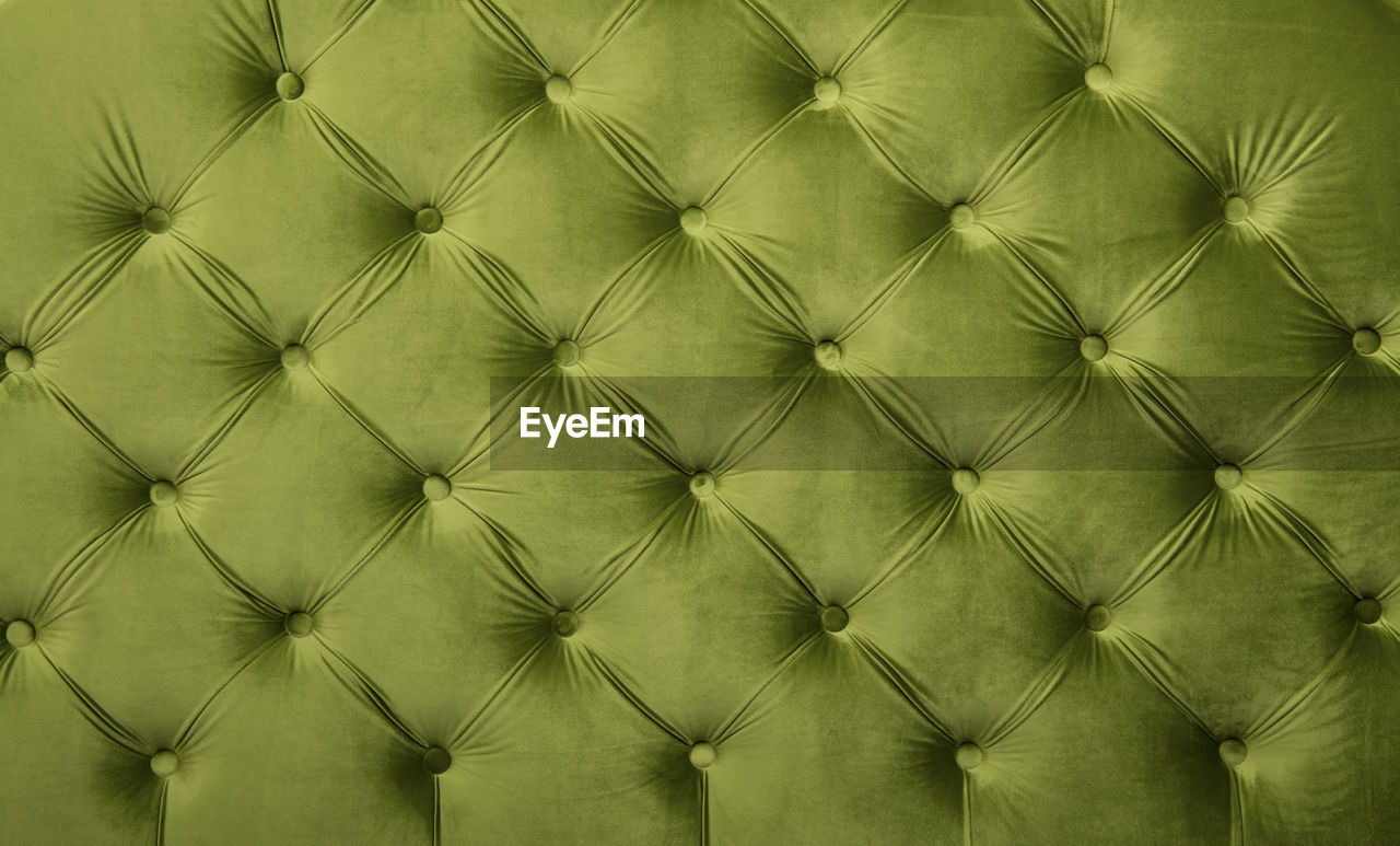 Full frame image of green chesterfield furniture