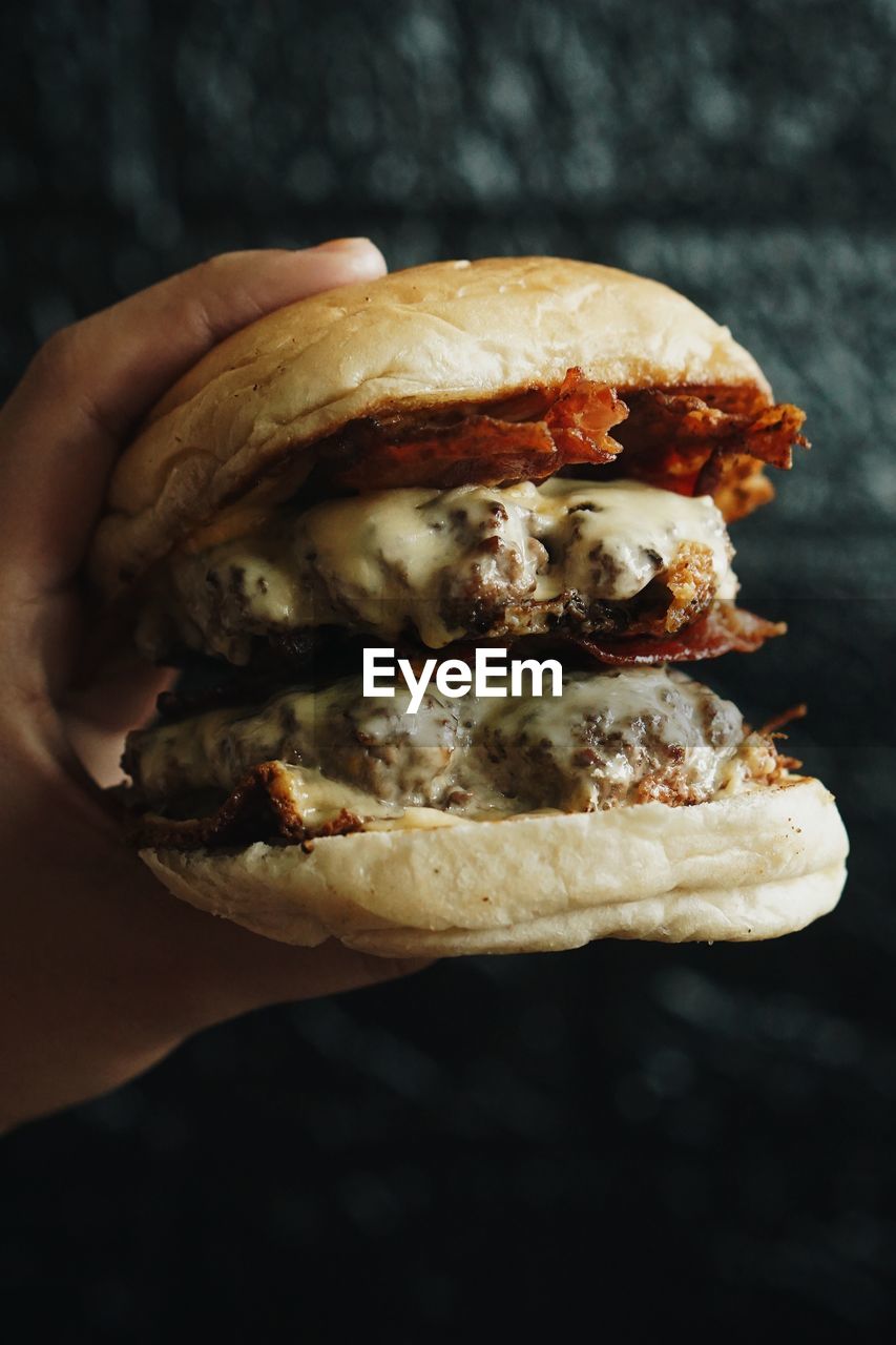 Close-up of hand holding burger