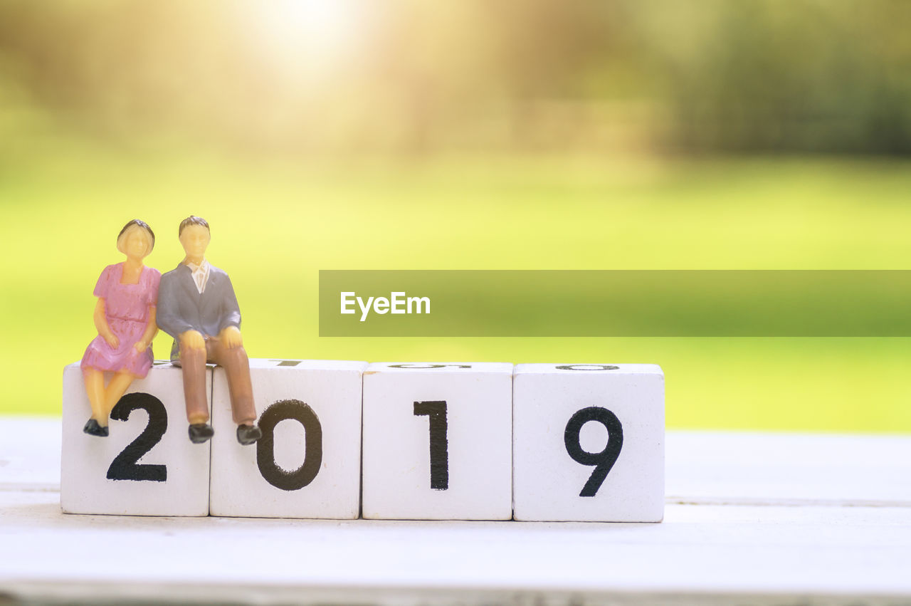 CLOSE-UP OF A TOY WITH TEXT ON TABLE