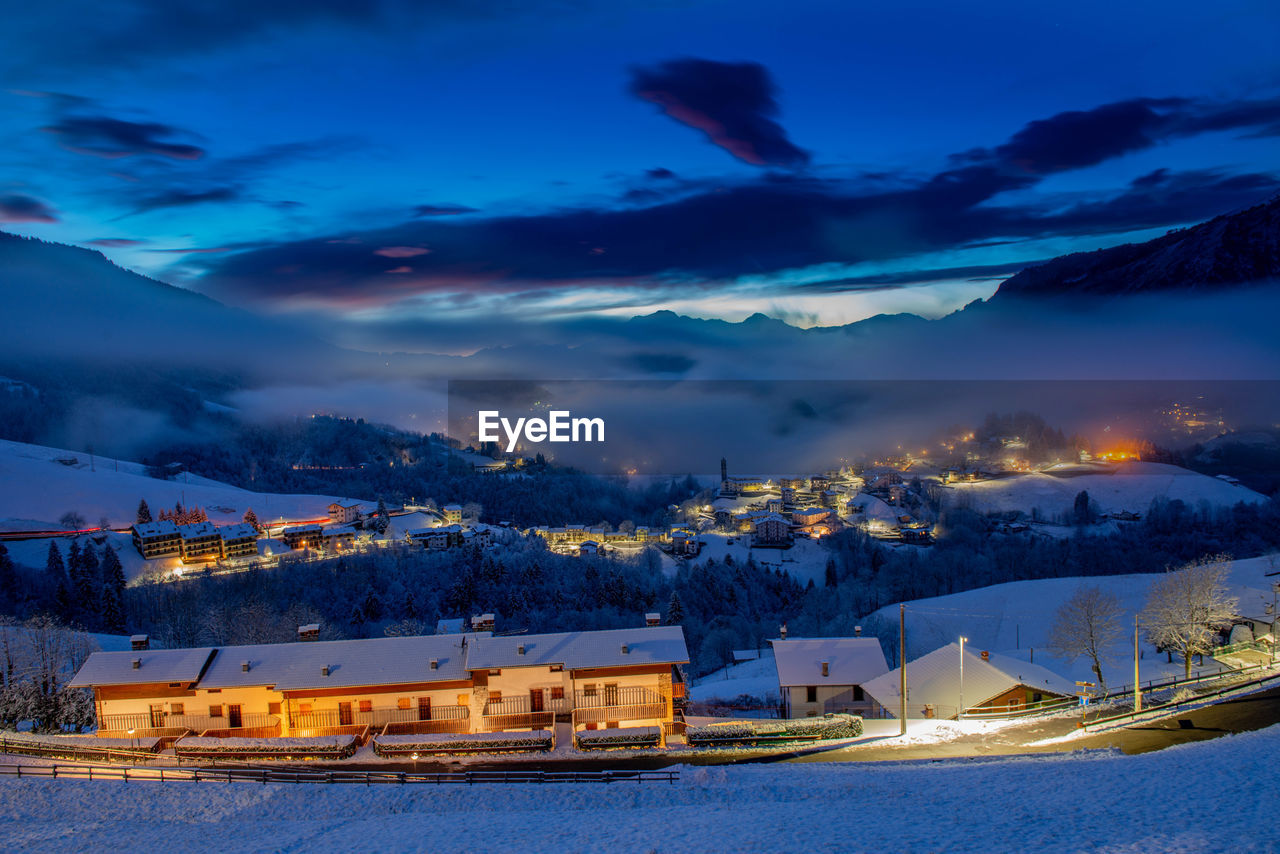 Mountain village after snowfall at sunset