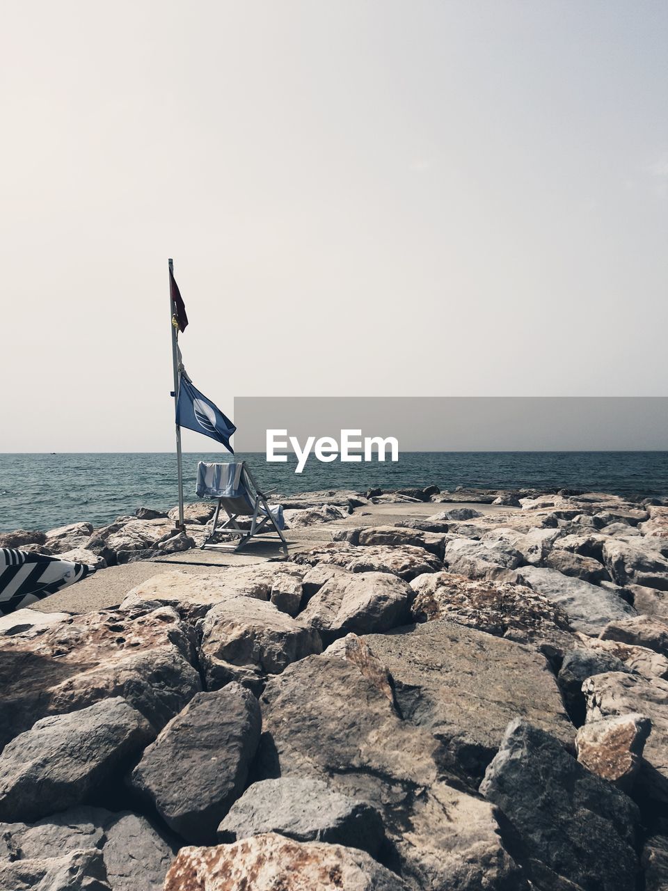 Scenic view of rocks on beach against clear sky